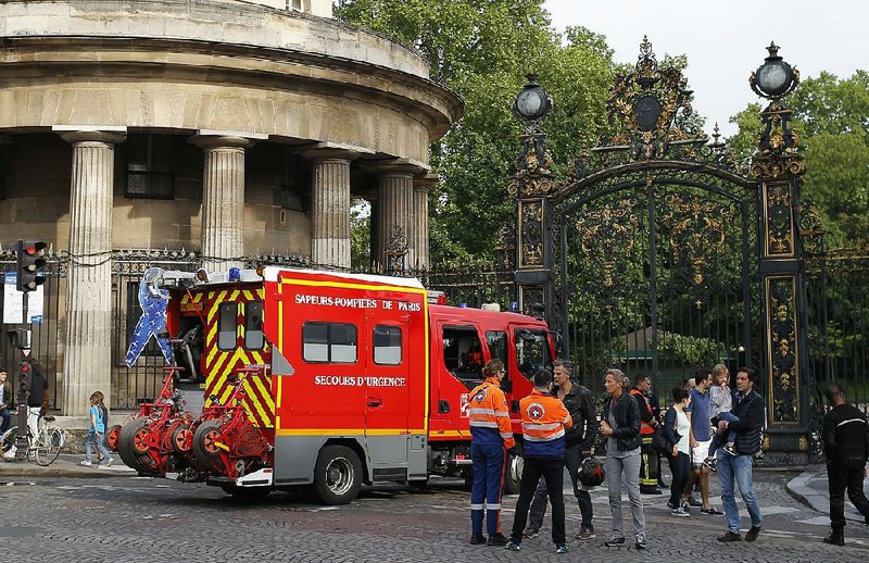 A firetruck waits Saturday at the entrance of Park Monceau in Paris after lightning injured 11 people at a child’s birthday party.