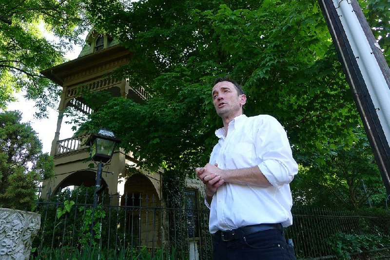 Dakota Buck leads a ghost tour Wednesday in front of Penn castle in Eureka Springs. Neighbors have complained that the Haunted Eureka Springs tour company is disrupting the peace and quiet of their historic neighborhood. 