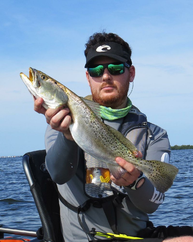 French journalist Vincent Le Masson admires one of the speckled sea trout he caught while fishing near the author recently in Pine Island Sound at Pineland, Fla. Video can be found at arkansasonline./com/videos