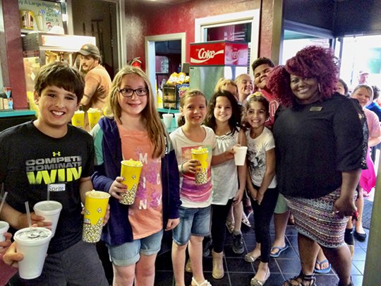 Submitted photo Sykes in Malvern funded a final trip of the school year for students in third and fourth grade from Lakeside Intermediate School. Chitara Stuart, right, a member of the Sykes recruiting team, met students at the Ritz Theatre in Malvern.