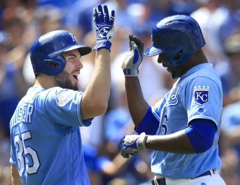 Kansas City center fielder Lorenzo Cain (right) is congratulated by first baseman Eric Hosmer after hitting a home run during the eighth inning of the Royals’ 5-4 come-from-behind victory over the Chicago White Sox on Sunday.