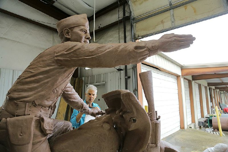 Kevin Kresse sculpts finishing details Oct. 23 on his monumental likeness of Gen. William O. Darby in a work shed attached to the Martin Borchert Co. in North Little Rock.