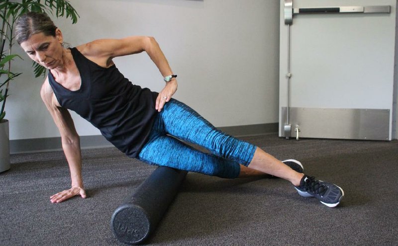 Marie Kolstad does step 1 of the IT Band Foam Roller exercise 