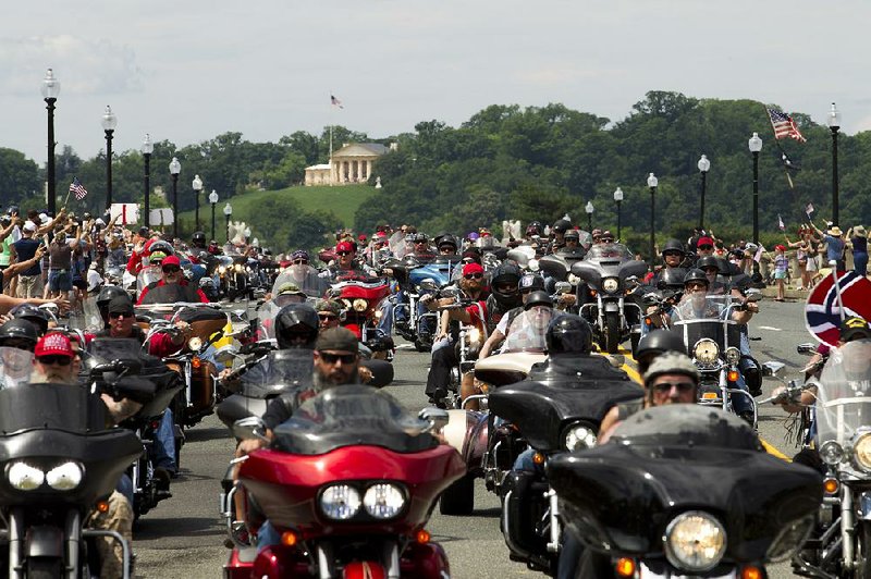 Participants in the Rolling Thunder motorcycle rally ride past Arlington Memorial Bridge on Sunday in Washington.