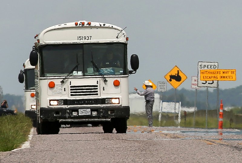 Texas Department of Criminal Justice prisoners are evacuated from the Terrell and Stringfellow Units Sunday, May 29, 2016, in Rosharon, Texas.  