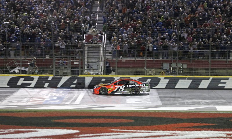 Martin Truex Jr. crosses the finish line to win the Coca-Cola 600 on Sunday.