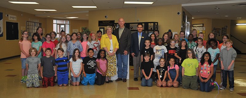 The Sentinel-Record/Mara Kuhn Center, from left, Park Magnet School Principal Diane Smith, state Rep. Bruce Cozart, R-District 24, and Hot Springs School District Superintendent Mike Hernandez, gather with children Thursday at the school after Cozart presented them with two checks for $25,726.19 for a Top 5 Percent Performance, and Top 5 Percent Group.