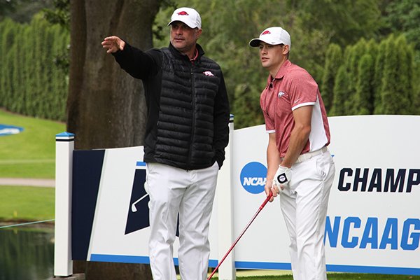 Arkansas golf coach Brad McMakin talks with Taylor Moore during the first round of the NCAA Championships on Friday, May 27, 2016, at Eugene Country Club in Eugene, Ore. 