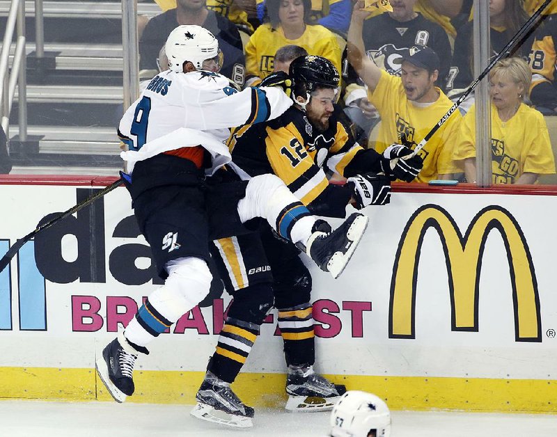 San Jose’s Dainius Zubrus checks Pittsburgh Ben Lovejoy during the first period in Game 1 of the Stanley Cup Final on Monday. The Penguins grabbed a 1-0 series lead with a 3-2 victory.