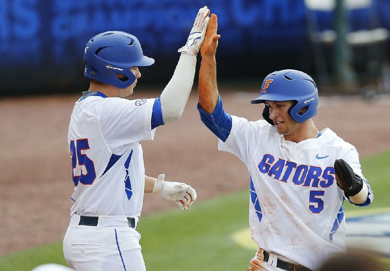 Florida’s Daniel Reyes (left) and Dalton Guthrie helped lead the Gators to the No. 1 overall seed in the NCAA Division I baseball tournament. Seven SEC teams received bids in the field, including a record four that were awarded national seeds.