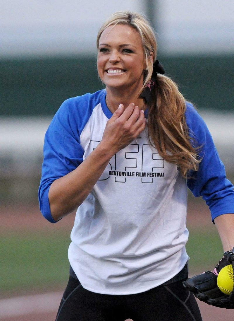 Jennie Finch, Olympic gold-medalist softball pitcher, warms up before pitching for Geena Davis' team during the 'A League of Their Own' celebrity softball game, part of the Bentonville Film Festival, on Thursday May 7, 2015 at Arvest Ballpark in Springdale. 