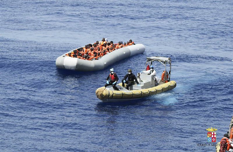 This undated image made available Monday by the Italian navy shows migrants being rescued at sea.
