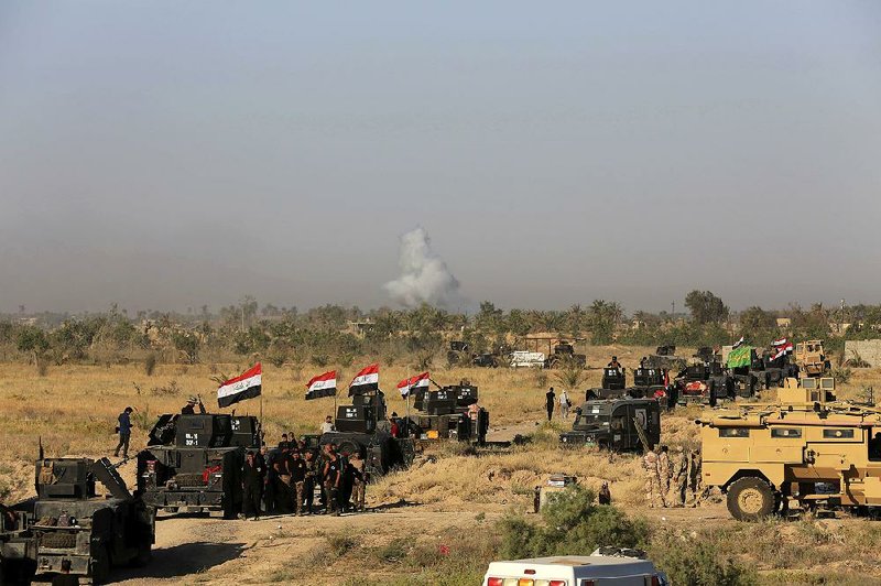 Smoke rises Monday as Iraqi military forces prepare to begin an offensive into the Islamic State-held city of Fallujah.