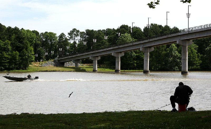 In this file photo fisherman checks his line Saturday near the Two Rivers Park Bridge at the confluence of the Arkansas and Little Maumelle rivers.