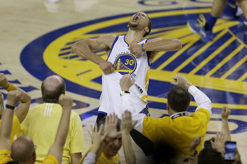 Two-time MVP Stephen Curry reacts after hitting a three-pointer late in the fourth quarter against Oklahoma City in Game 7 of the NBA Western Conference final Monday night. Curry scored 24 of his game-high 36 points in the second half to carry Golden State back to the NBA Finals with a 96-88 victory. The Warriors trailed 48-42 at the halftime but outscored the Thunder 29-12 in the third quarter to take over and advance to face Cleveland in the championship series for the second year in a row.