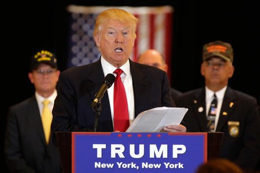 Republican presidential candidate Donald Trump reads from a list of donations to veteran's groups during a news conference in New York on Tuesday, May 31, 2016.