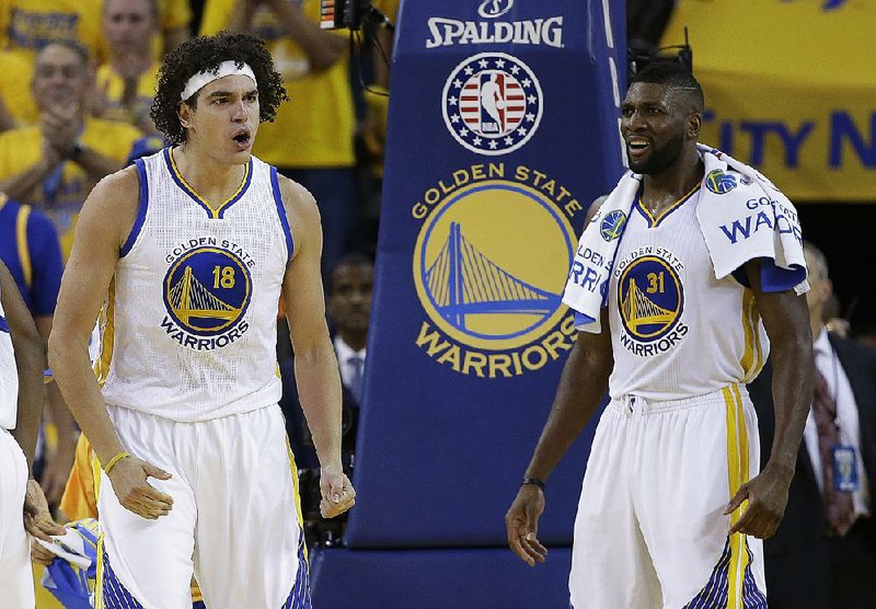 Anderson Varejao (18)  of the Golden State Warriors is the first player to be on the roster of both teams in the NBA Finals during the same season. He is shown with Golden State Warriors center Festus Ezeli (31).