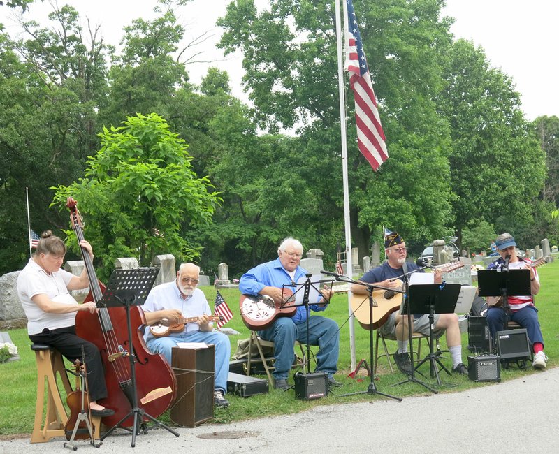 Photo by Susan Holland Members of the Old Town String Band played patriotic music for the Memorial Day service at Hillcrest Cemetery in Gravette. Members of the band are Linda Lefevere, Jeff Davis, Bill Mattler, Al Blair and Mary Bourn.