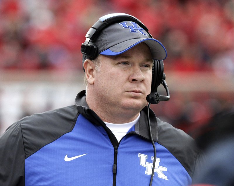 FILE - In this Saturday, Nov. 29, 2014 file photo, Kentucky head coach Mark Stoops looks on during the half of an NCAA college football game against Louisville in Louisville, Ky. Steve Shaw has a busy week at the Southeastern Conference's annual meetings. Shaw, the league's coordinator of officials, is getting SEC coaches and administrators prepared for centralized replay, an experimental effort between the SEC office's command center and the replay official at games.(AP Photo/Garry Jones, File)