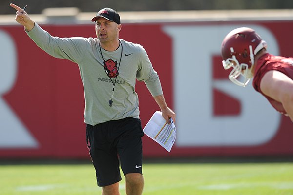 Arkansas assistant coach Barry Lunney Jr. directs his players Thursday, March 31, 2016, during practice at the university's practice field on campus in Fayetteville.