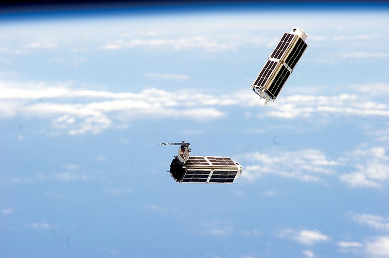 A set of small satellites, photographed by an International Space Station crew member, drifts through space in this file photo. Experts estimate that 210 satellites weighing less than 110 pounds will be launched this year. 