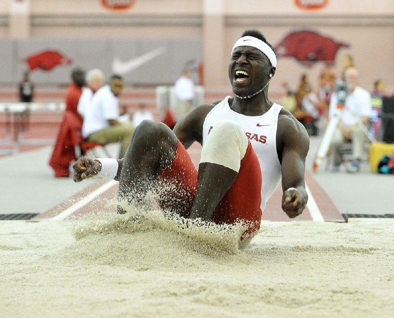 NWA Democrat-Gazette/Michael Woods --01/31/2015--w@NWAMICHAELW... University of Arkansas triple jumper Clive Pullen lands a jump in the Mens triple jump finals Saturday afternoon the Razorback Invitational track meet at the Randal Tyson Track Complex in Fayetteville. Pullen finished 2nd with a jump of 15.69m.