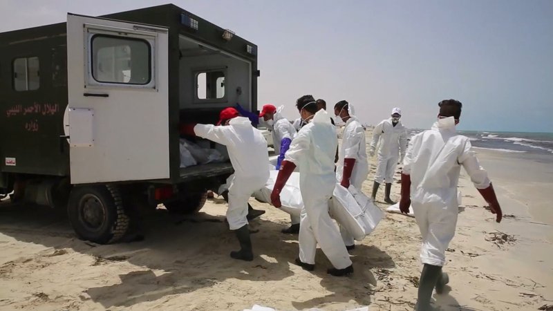 Rescue workers remove the body of a victim Friday near Zwara, Libya, where more than 110 bodies were pulled from the Mediterranean Sea after a smuggling boat carrying mainly African migrants sank.