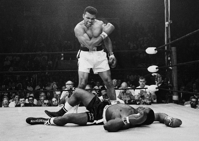 Muhammad Ali stands over Sonny Liston after knocking him out in the first round to retain the world heavyweight title on May 25, 1965, in Lewiston, Maine.