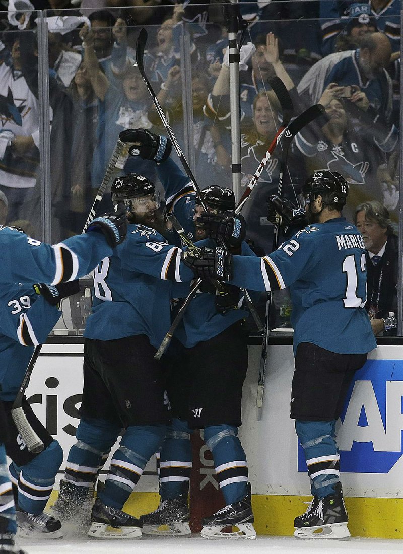 San Jose right wing Joonas Donskoi (center) is surrounded by teammates after his goal in overtime gave the Sharks a 3-2 victory over Pittsburgh in Game 3 of the NHL Stanley Cup Final on Saturday and cut the Penguins’ series lead to 2-1.