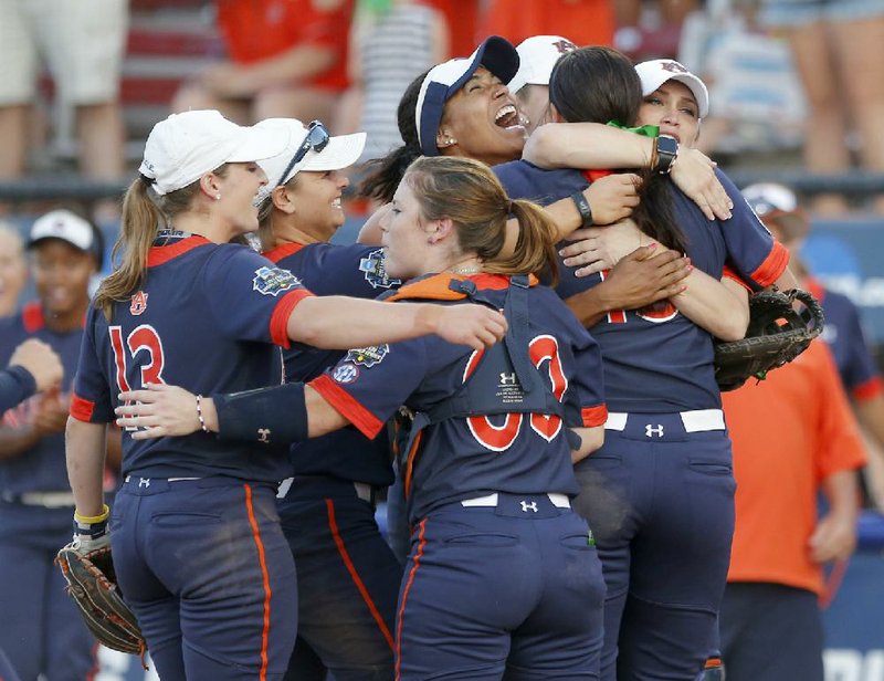 Auburn players celebrate following the Tigers’ 4-3 victory over Georgia at the Women’s College World Series in Oklahoma City.