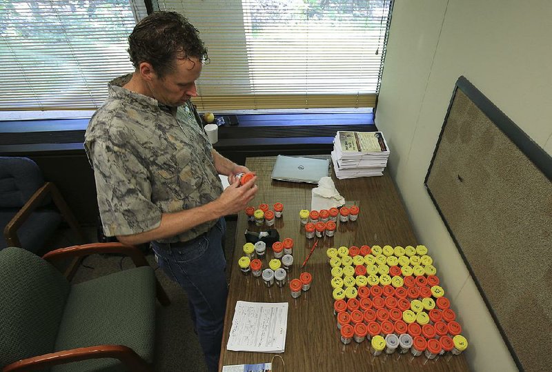 Cory Gray, deer program manager for the Arkansas Game and Fish Commission, prepares samples of deer tissue for shipping to a laboratory to be tested for chronic wasting disease.