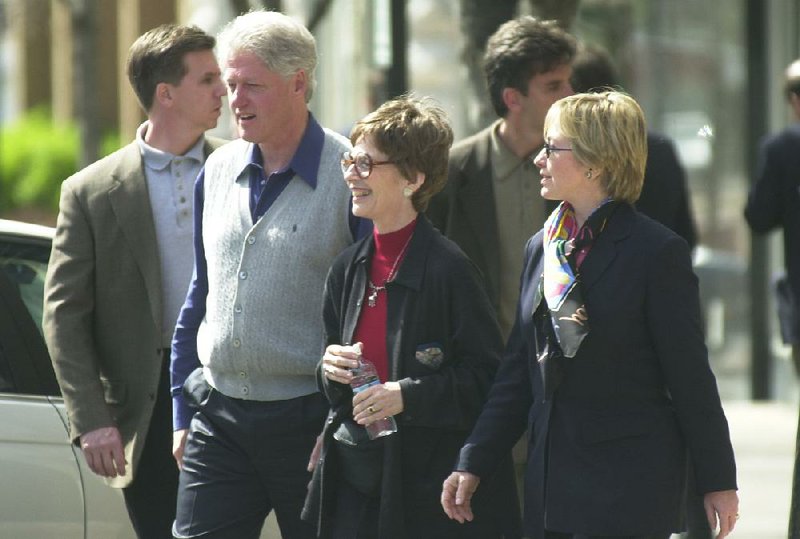 Bill and Hillary Clinton walk through downtown Fayetteville with Diane Blair (center) during a visit in April 2000 while Clinton was still president.