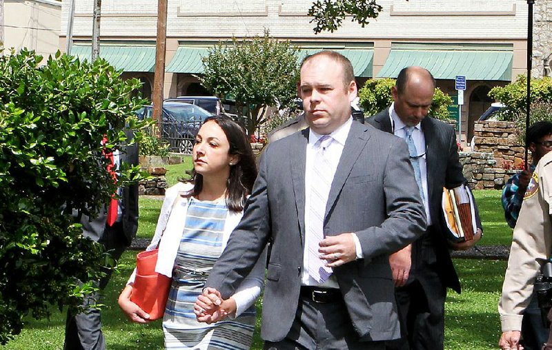 Garland County circuit Judge Wade Naramore and his wife, Ashley, leave the Garland County Courthouse on Friday after special Circuit Judge John Langston granted the prosecution’s request to delay Wade Naramore’s negligent-homicide trial in the death in a hot car last summer of the couple’s son.