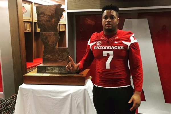 Arkansas defensive line signee Briston Guidry poses with the Golden Boot trophy.