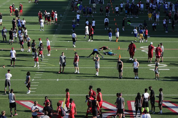 Players warm up before the start of the All Arkansas satellite camp Sunday, June 5, 2016, at War Memorial Stadium in Little Rock.