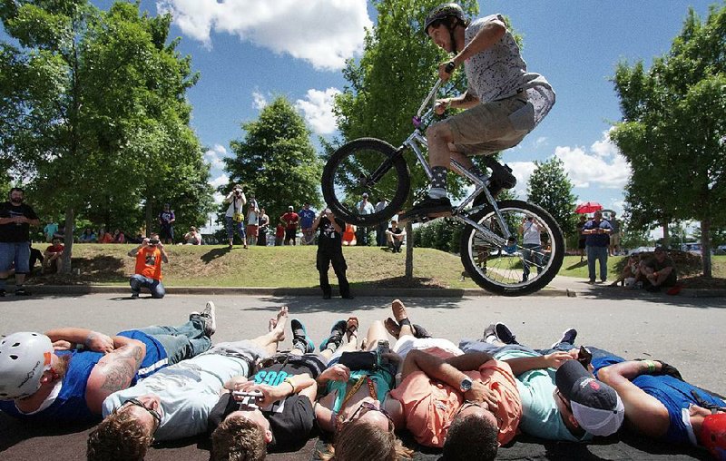 Mike Green of Memphis does his signature “Bunny Hop” over seven people Sunday during the Southern BMX Stunt Show at Riverfest in Little Rock.