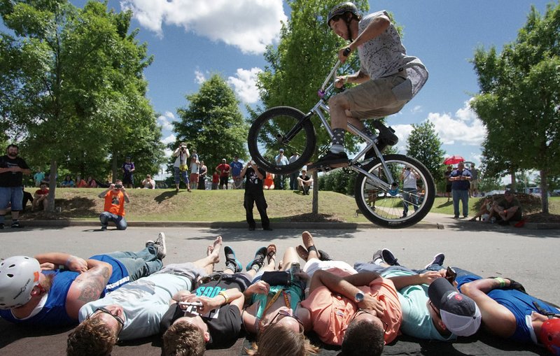 Arkansas Democrat-Gazette/MITCHELL PE MASILUN Mike Green of Memphis does his signature "Bunny Hop" over seven people during the Southern BMX Stunt Show at Riverfest Sunday, June 5, 2016.
