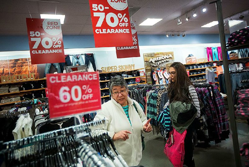 Shoppers browse clothing at a J.C. Penney store in the Queens Center Mall in New York in February. Retailers like J.C. Penney are leasing more space in their stores to other sellers to make stores more efficient and attract shoppers.