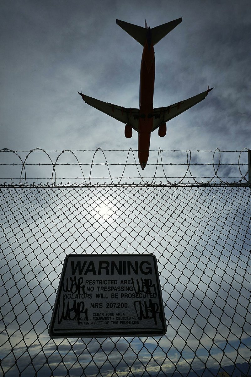 A plane lands at McCarran International Airport in Las Vegas in this file photo. Union officials said Monday that new air traffic control towers at the Las Vegas airport and at San Francisco International Airport must be modified to handle older technology for tracking flights, because the new system is unreliable.