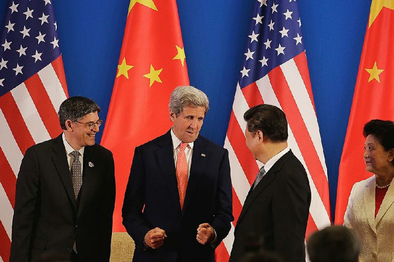 China’s President Xi Jinping chats Monday with U.S. Secretary of State John Kerry (center) and U.S. Treasury Secretary Jacob Lew (left) at the state guest house in Beijing during the opening ceremony for the eighth U.S.-China Strategic and Economic Dialogue  for the seventh U.S.-China High-Level Consultation on People-to-People Exchange.