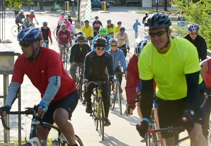 Riders wear helmets during the Square To Square ride in May on the Razorback Greenway. Helmets and cycling gloves help prevent rider injury.