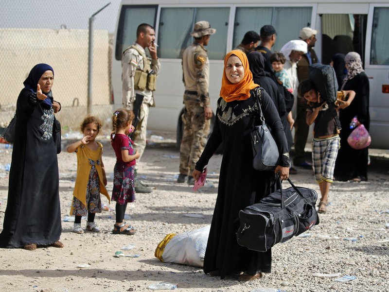 Displaced Iraqi families arrive to an Iraqi army camp after fleeing their homes during fighting between Iraqi security forces and the Islamic State group, outside Fallujah, Iraq, Saturday, June 4, 2016. The Iraqi army is attempting to retake the western city.