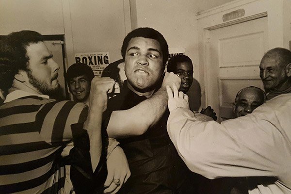 Arkansas football player Robin Smith wrestles with boxer Muhammed Ali on Jan. 3, 1978, in Miami. 