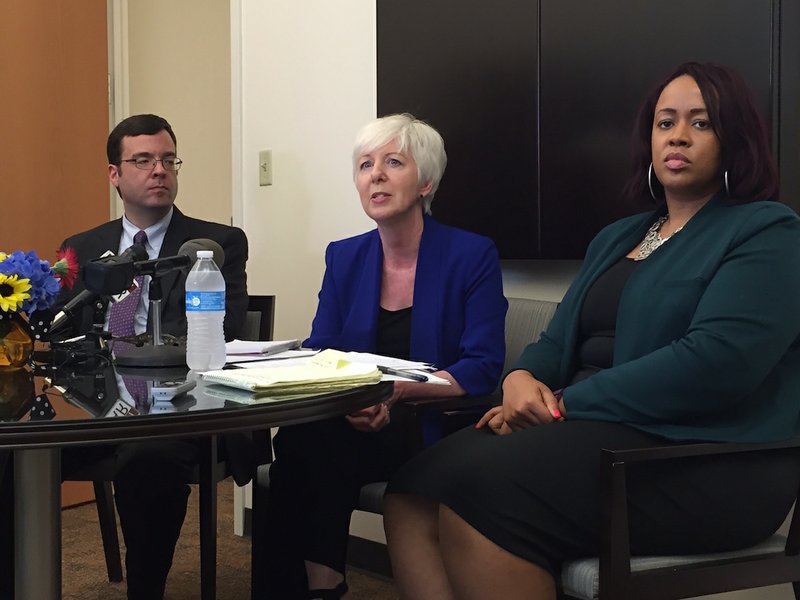 Arkansas Department of Human Services Director Cindy Gillespie, surrounded by deputy directors Mark White (left) and Keesa Smith, speaks Tuesday, June 7, 2016, during a news conference at her office in Little Rock.