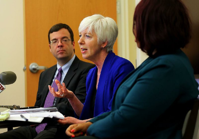 State Department of Human Services Director Cindy Gillespie (center), joined by deputy directors Mark White and Keesa Smith, discusses her plan Tuesday in Little Rock.