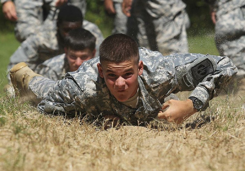 Kody Frazier, 15, of Brookland crawls through a sand pit Tuesday morning as Junior Reserve Officer Training Corps cadets tackle an obstacle course at Camp Robinson in North Little Rock as part of a weeklong leadership training camp. 