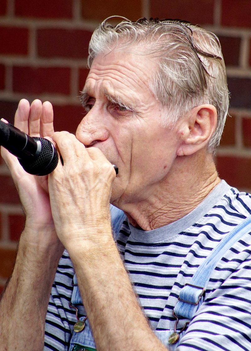 Photo by Randy Moll Glenn Corbin of Siloam Springs was playing the harmonica and providing Christian music at the Kids&#8217; Free Fun Day held Saturday at the Gentry Medical Center.