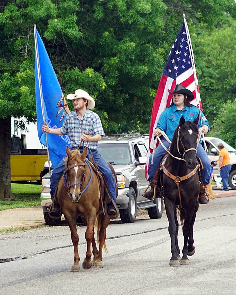 Photo by Randy Moll Riders carried the U.S. Flag and the Oklahoma State Flag at the head of the parade during the Old Settlers&#8217; Day celebration Saturday in Colcord, Okla.