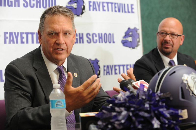 Bill Blankenship (left), newly hired football coach at Fayetteville, speaks Wednesday alongside Matthew Wendt, incoming superintendent, during a press conference to announce Blankenship’s hire in the Adams Leadership Center at Fayetteville High School. Blankenship served as coach at Tulsa University from 2011-14 and coached Tulsa Union High School from 1992-2005. 