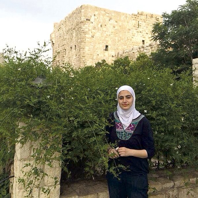 Kholoud Sawaf pauses to smell the jasmine in Damascus, the “city of Jasmine.” A graduate of the University of Arkansas, she is working with TheatreSquared on a Middle Eastern version of “Romeo and Juliet.”